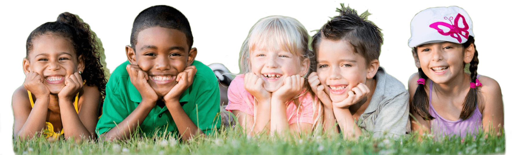 A group of elementary age children laying side by side with there elbows in the grass and their heads resting in their hands.